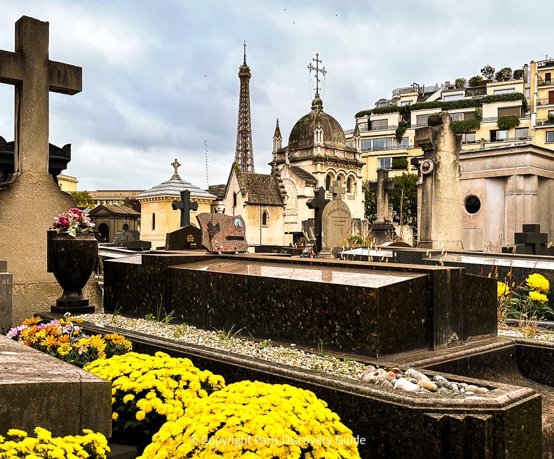 Colorful bouquets of flowers on one of the newer tombs at Pere Lachaise Cemetery