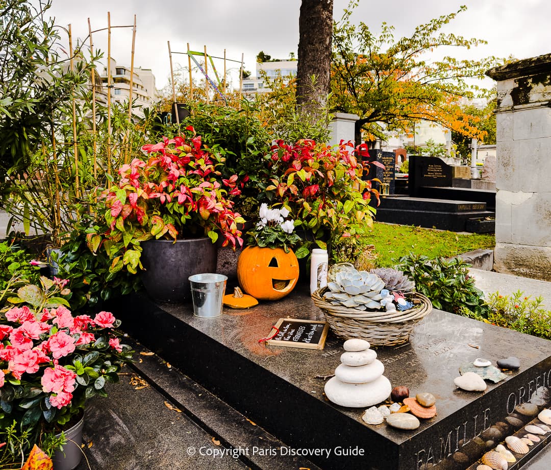 Colorful bouquets of flowers on one of the newer tombs at Pere Lachaise Cemetery