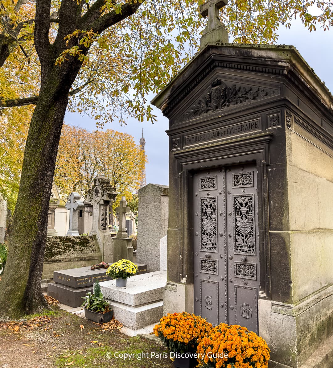 Colorful bouquets of flowers on one of the newer tombs at Pere Lachaise Cemetery