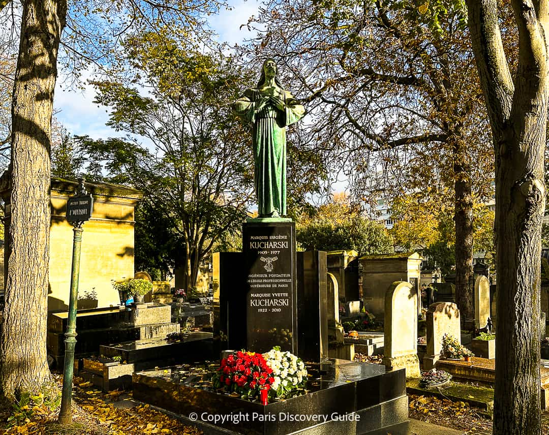 Colorful bouquets of flowers on one of the newer tombs at Pere Lachaise Cemetery