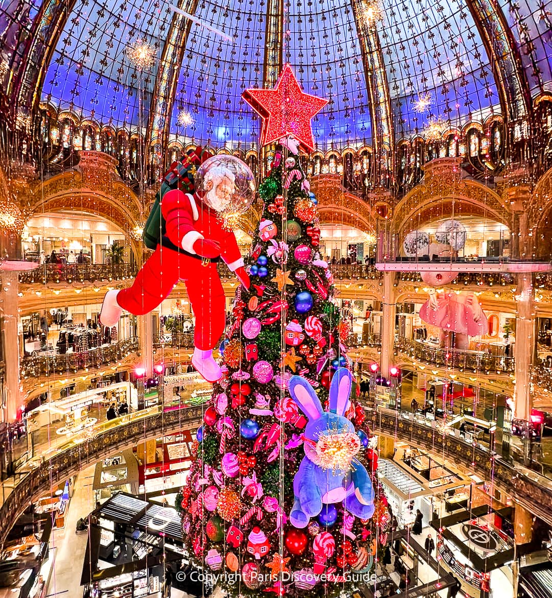 A giant candy tree floats from Galeries Lafayette's domed ceiling