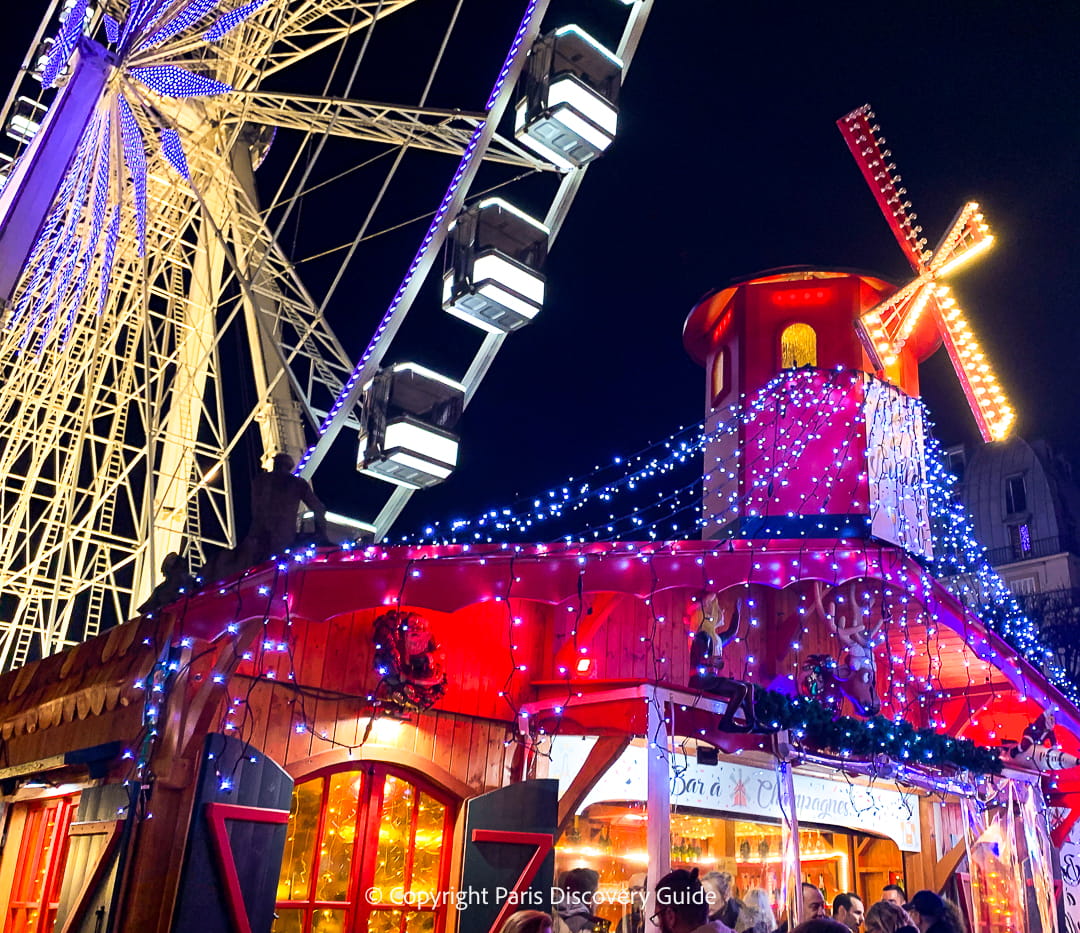 The brightly lighted Ferris Wheel and Champagne Bar at the Tuileries Christmas Market