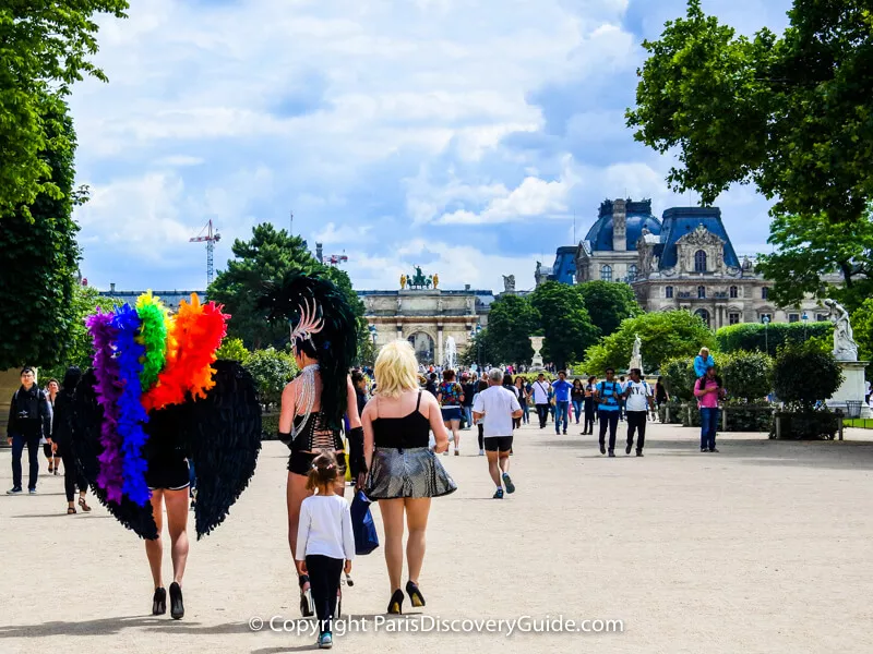 Participants in Paris Pride Parade walking in Tuileries Garden