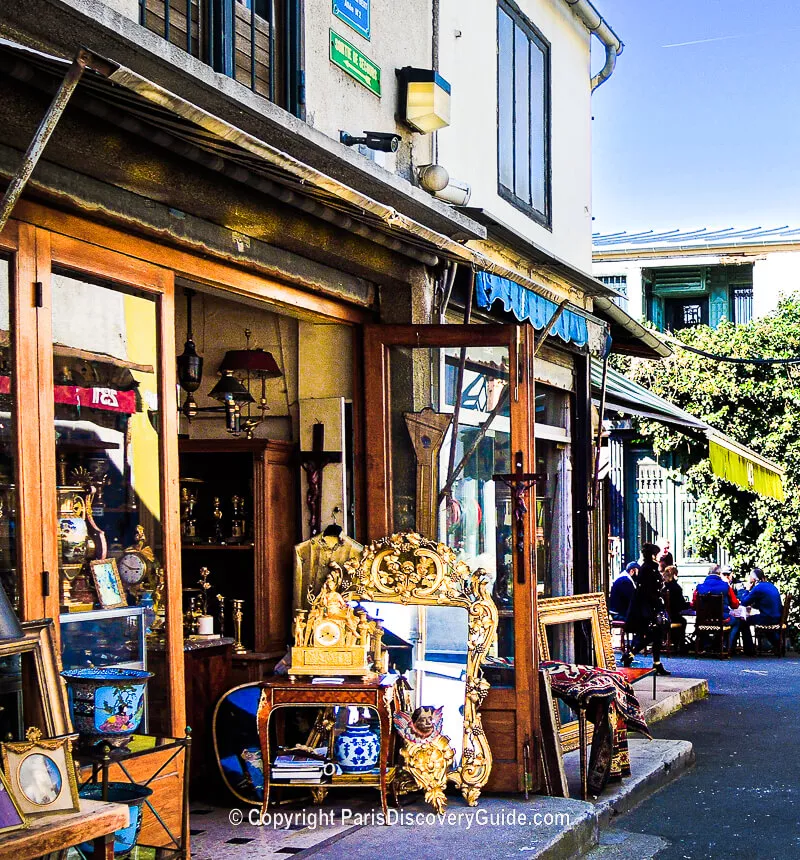 Mirrors, antique clocks, other collectibles at shop in the Marché Paul Bert market at Les Puces