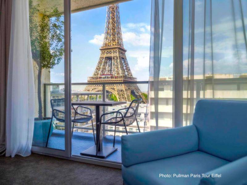 Paris Hotel with mini Eiffel Tower as seen through the fountains